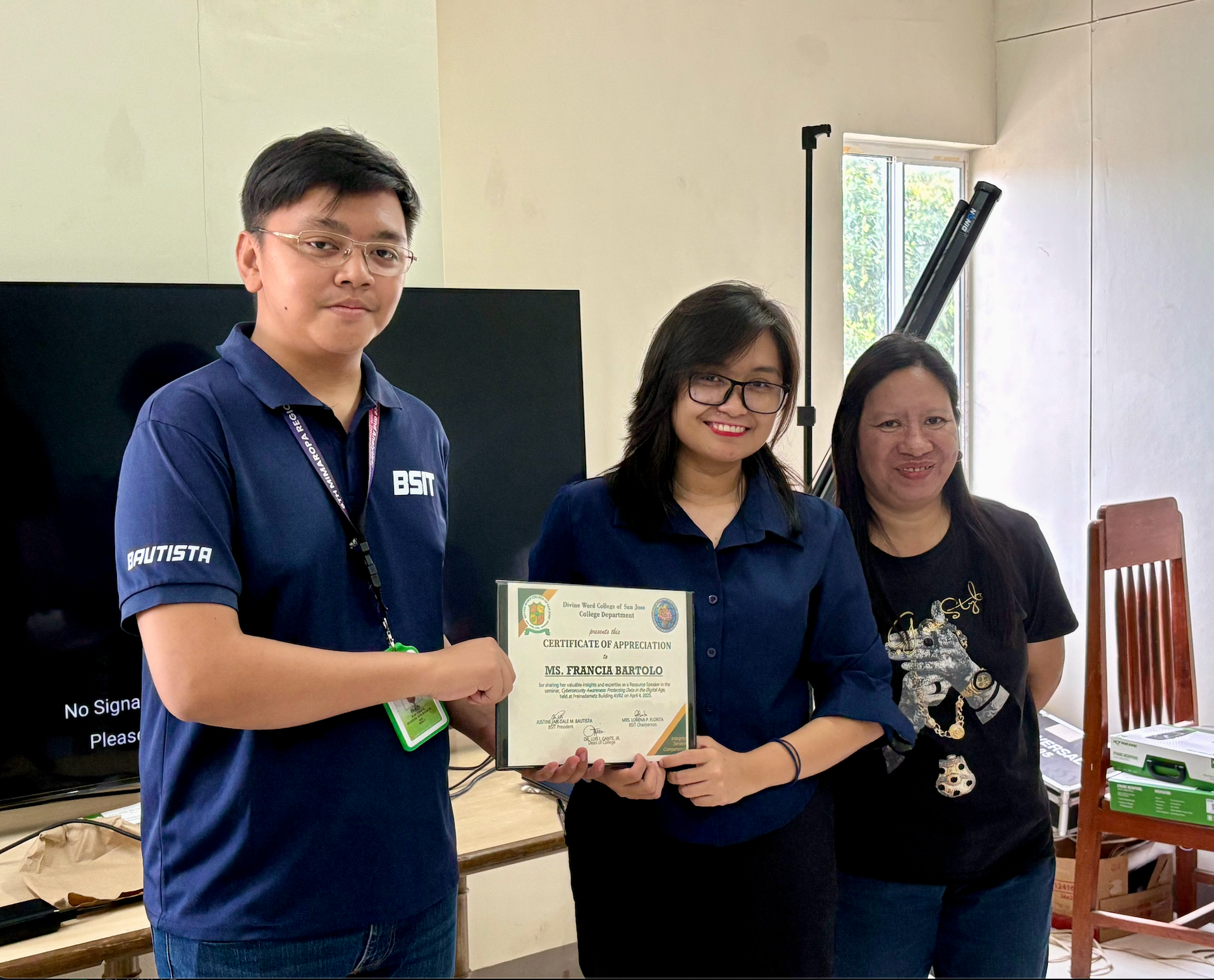Francia Bartolo receiving a certificate after facilitating a cybersecurity awareness session at Divine Word College of San Jose